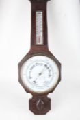 Edwardian oak cased barometer/thermometer, with stylised foliate carved pediment and ivorine dial,