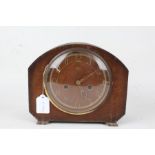 Smiths Enfield mantel clock, with arched case, the pierced brass effect dial with Arabic numerals,