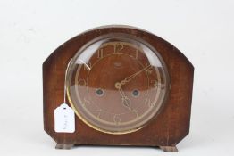 Smiths Enfield mantel clock, with arched case, the pierced brass effect dial with Arabic numerals,