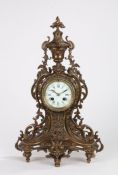 19th Century French brass mantel clock, the foliate cast urn form pediment above a pierced scroll