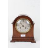 Early 20th Century mahogany mantel clock, the arched case having a silvered dial with Roman