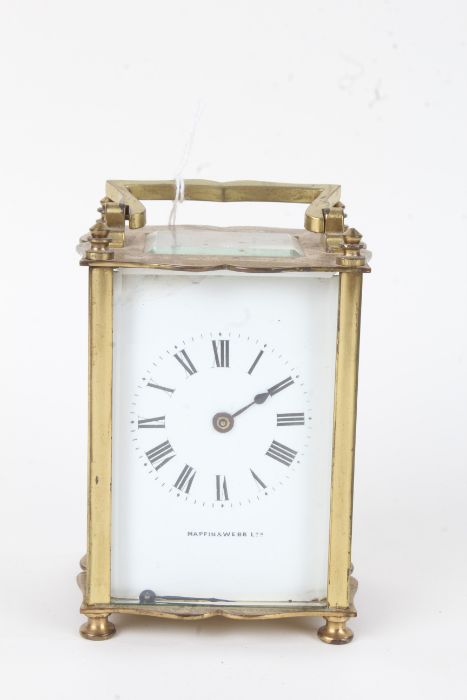 French brass carriage clock, the angular handle above a white dial with Roman numerals and retailers