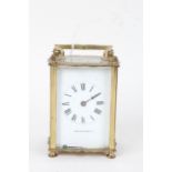 French brass carriage clock, the angular handle above a white dial with Roman numerals and retailers