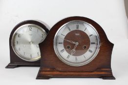 Two Smiths Enfield mantle clocks, the first having a bakelite arch shaped case with silvered dial,