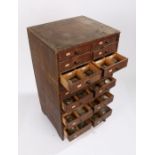 Small wooden chest of 20 drawers containing wrist and pocket watch glasses, various sizes (qty)