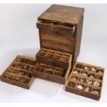 Small wooden chest of six drawers containing wrist and pocket watch glasses, various sizes (qty)