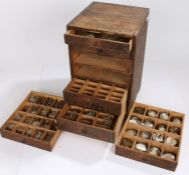 Small wooden chest of six drawers containing wrist and pocket watch glasses, various sizes (qty)