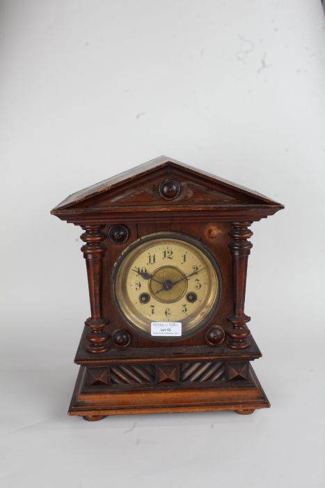 Junghans walnut cased mantel clock, the triangular pediment with turned finials above the ivorine