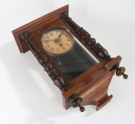 Edwardian mahogany wall clock, the cream dial with Arabic numerals, the glazed door flanked by