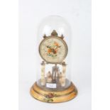 Anniversary clock, the foliate decorated dial with Arabic numerals, housed under a glass dome with