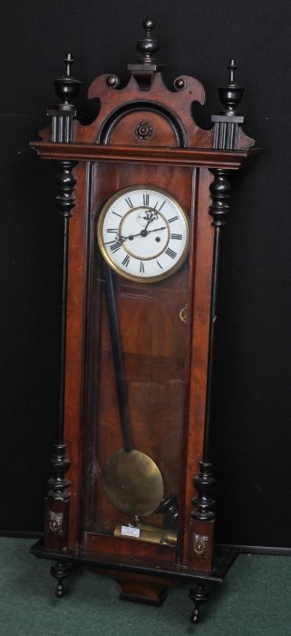 Vienna regulator wall clock, the turned and foliate pediment above the white dial with Roman