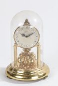 Kern Germany anniversary clock, the dial with Roman numerals above four rotating gilt orbs, housed