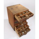 Small chest of eight drawers containing wrist and pocket watch glasses (qty)