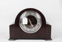 Enfield Clock Co mantel clock, with domed mahogany case, the silvered dial with Arabic numerals,
