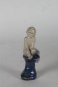 Royal Doulton stoneware figure, by Leslie Harradine, modelled as a seated boy on a blue glazed