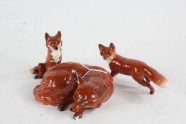 Beswick fox, modelled in a recumbent position (chip to foot), together with two Beswick foxes