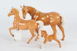Two Beswick horses (largest with one ear AF), together with a similar Beswick foal (3)