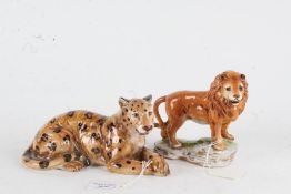 Two porcelain figures depicting a lion and a leopard, with Crowned S marks to the bases (2)