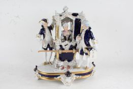 Royal Dux porcelain figural group depicting a lady in a sedan chair with two bearers, on a scroll