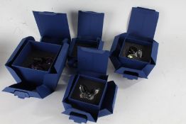 Four Swarovski crystal glass butterflies, to include two amethyst examples, all boxed (4)