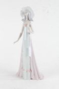 Lladro figurine, in the form of a lady wearing a flowing dress and hat, 35cm, together with a Nao