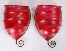 Pair of 20th century skin wall lights, in red with metal frames, 34cm high (2)