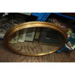 Two gilt framed wall mirrors, one of oval form, 79cm wide, the other of rectangular form, 65cm