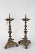 Pair of 17th century style brass pricket candlesticks, each with knopped columns raised on