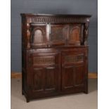 17th century and later oak court cupboard, having carved frieze above a single panelled door,