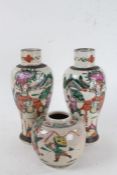 Two Japanese vases and a ginger jar, decorated with fighting figures, some on horseback, amongst