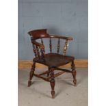 Edwardian smokers bow elbow chair, with spindle turned back and dished seat, raised on turned legs