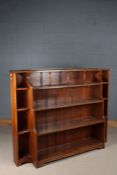 Substantial oak open bookcase, the waterfall central section with turned spindles to the top,