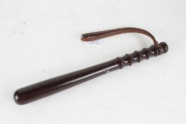 Lignum vitae truncheon, with brown leather strap, 38cm long