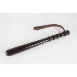 Lignum vitae truncheon, with brown leather strap, 38cm long