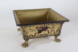 Painted metal jardinière, of square tapering form the gilt body with black borders and central