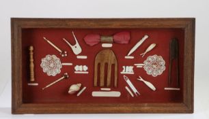 Oak glazed display case enclosing a collection of needlework accessories, to include lace bobbins