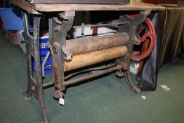 Cast iron mangle, painted in green and red, with folding pine top, signed W.J.Harris & Co., Peckham,