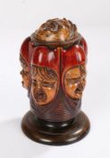 Late 19th Century string box, with an open mouthed face for the string above five carved children'