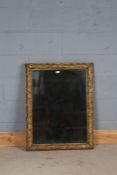 Gilt framed wall mirror, the leaf and berry decorated gilt frame housing the rectangular mirror