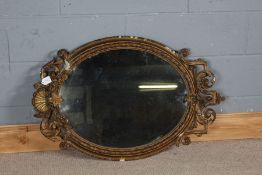 Victorian gilt wall mirror, the shell, scroll and foliate decorated frame housing the oval mirror