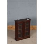 Small mahogany cupboard, the cavetto pediment above two glazed doors, 44cm wide