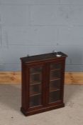 Small mahogany cupboard, the cavetto pediment above two glazed doors, 44cm wide