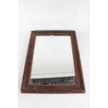 Early 20th Century pine wall mirror, the rectangular mirror plate housed within a stained moulded
