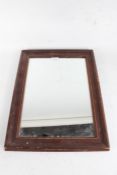 Early 20th Century pine wall mirror, the rectangular mirror plate housed within a stained moulded