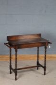 Edwardian oak washstand, the wavy upstand and top flanked by two towel rails, on bobbin turned