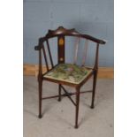 Art Nouveau corner chair, the shaped cresting rail above a foliate marquetry inlaid splat back,