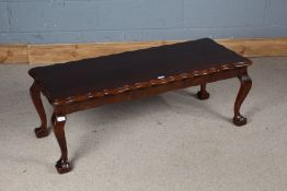 Mahogany coffee table, with scalloped rectangular top, raised on cabriole legs with claw and ball