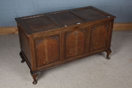 18th Century style oak coffer, with triple panelled lid and front, raised on squat cabriole feet,