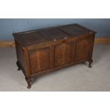 18th Century style oak coffer, with triple panelled lid and front, raised on squat cabriole feet,