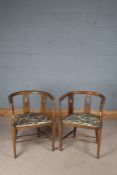 Pair of Edwardian elbow chairs, the curved top rail above three oval pierced boxwood strung
